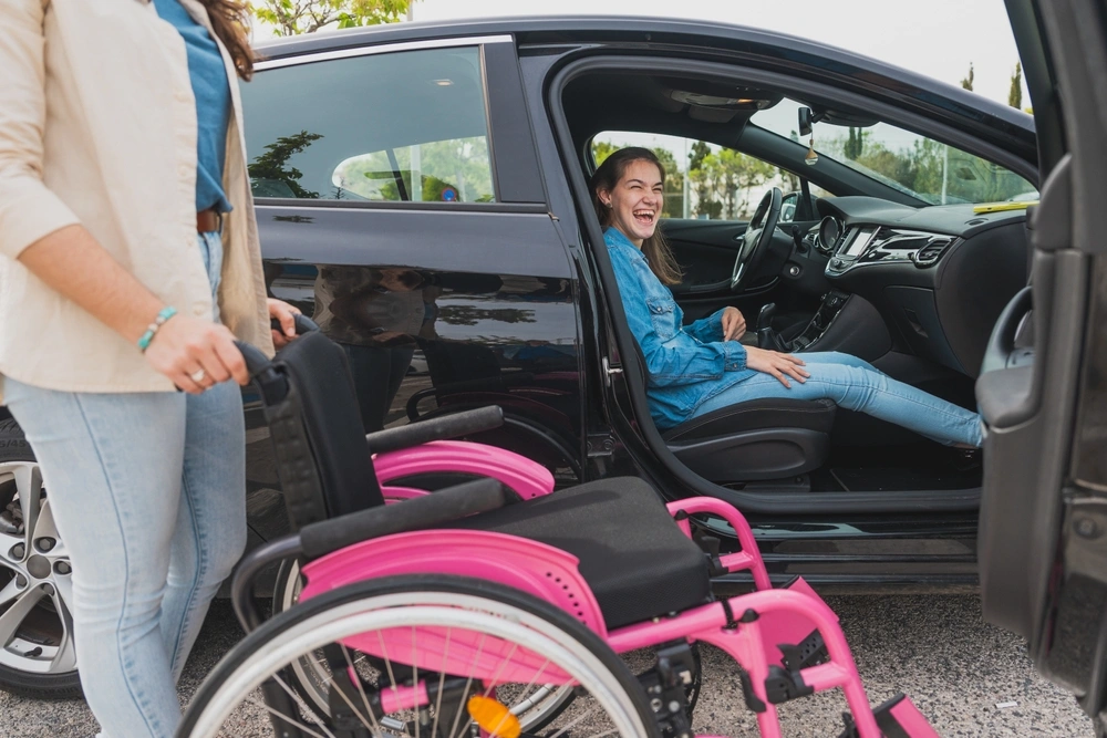 down syndrome girl sitting in a car and a wheelchair